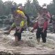 FOTO: Aksi kemanusiaan jajaran Polsek Candipuro, Kabupaten Lumajang, saat membantu gendong anak-anak sekolah menyeberangi derasnya aliran Sungai Regoyo